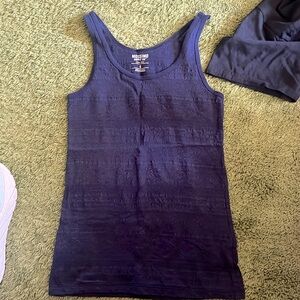 Two tank tops, one blue, one purple, with slight see through design